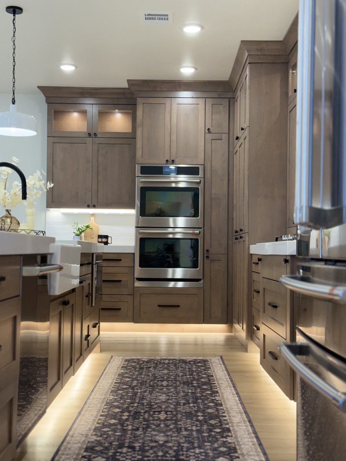 Premium kitchen with warm wood cabinets and double oven — a ChicProClean home